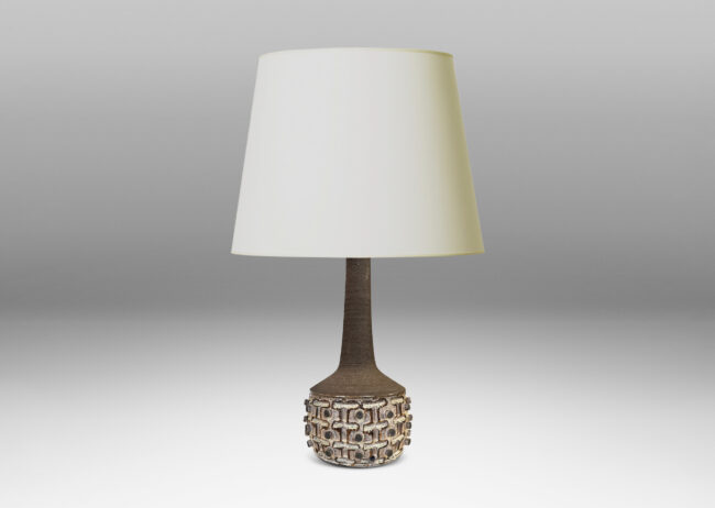 Gallery BAC swelling drum ornamented with carved cross pattern and applied dots, and tall neck, glazed in shiny ivory, matte brown and gray
