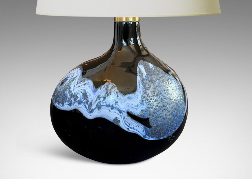 oblong forms with offset sprouting necks, in black with wavy nacreous collar