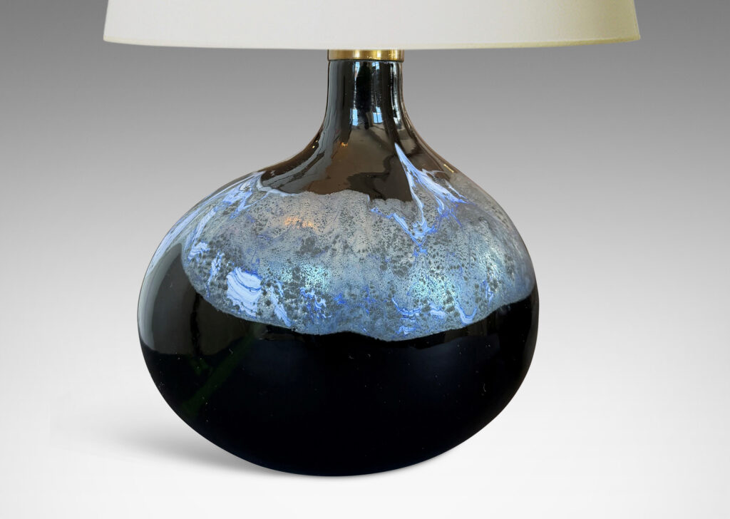 oblong forms with offset sprouting necks, in black with wavy nacreous collar