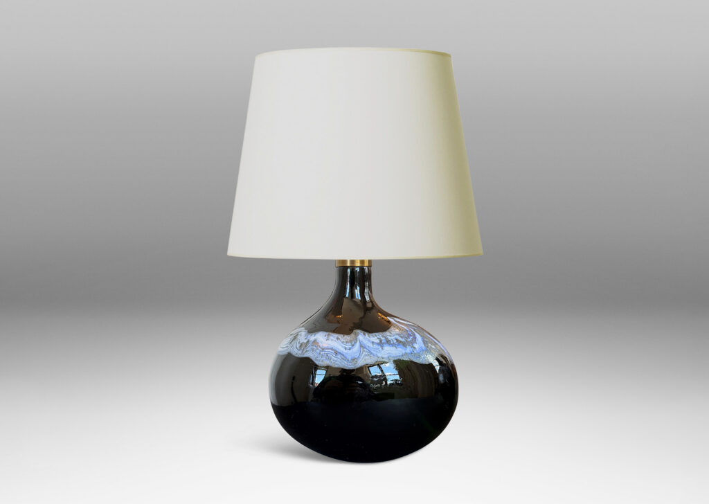 oblong forms with offset sprouting necks, in black with wavy nacreous collar