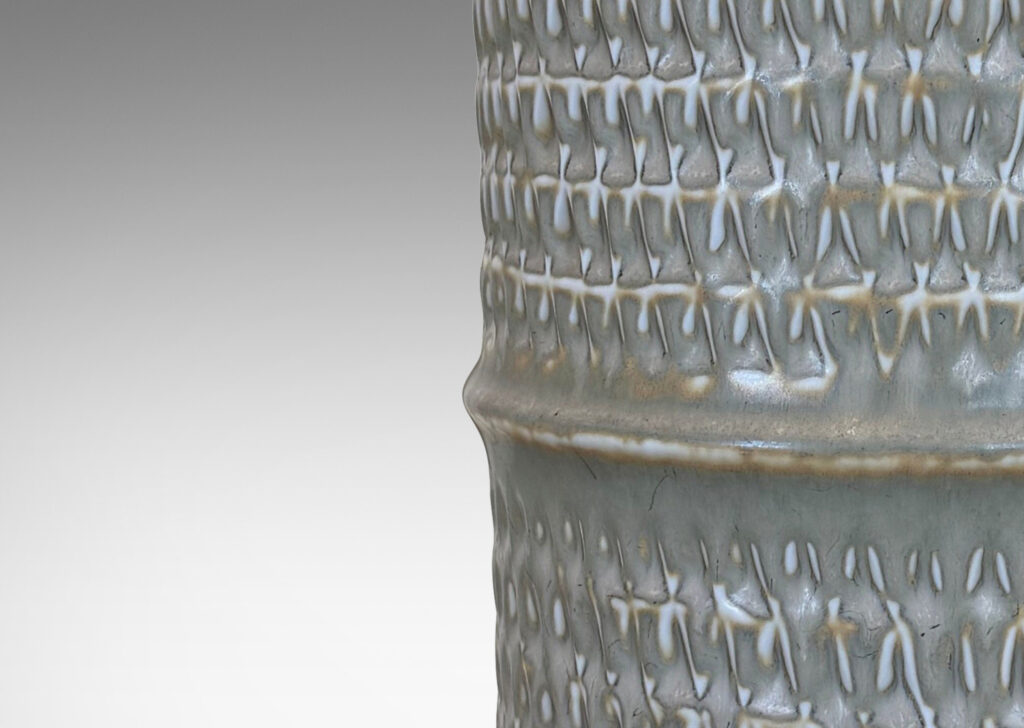 Gallery BAC large cylindrical forms with notched bands and relief rows of triangle motifs, glazed in light warm gray