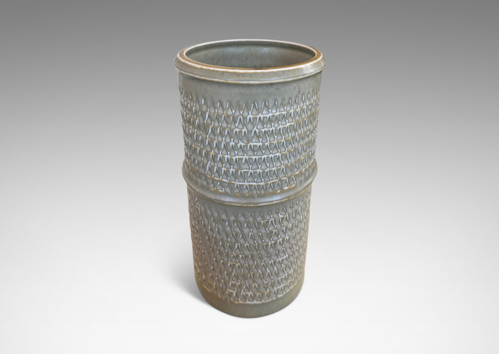 Gallery BAC cylindrical forms with notched bands and lips, and relief rows of triangle motifs, glazed in light warm gray