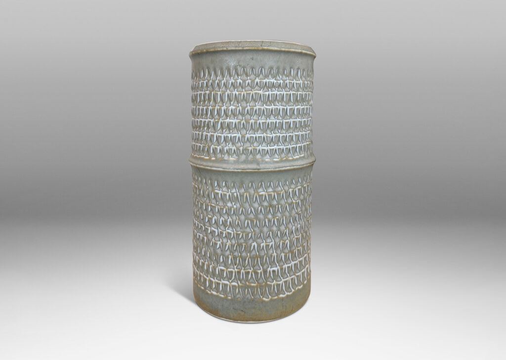 Gallery BAC cylindrical forms with notched bands and lips, and relief rows of triangle motifs, glazed in light warm gray