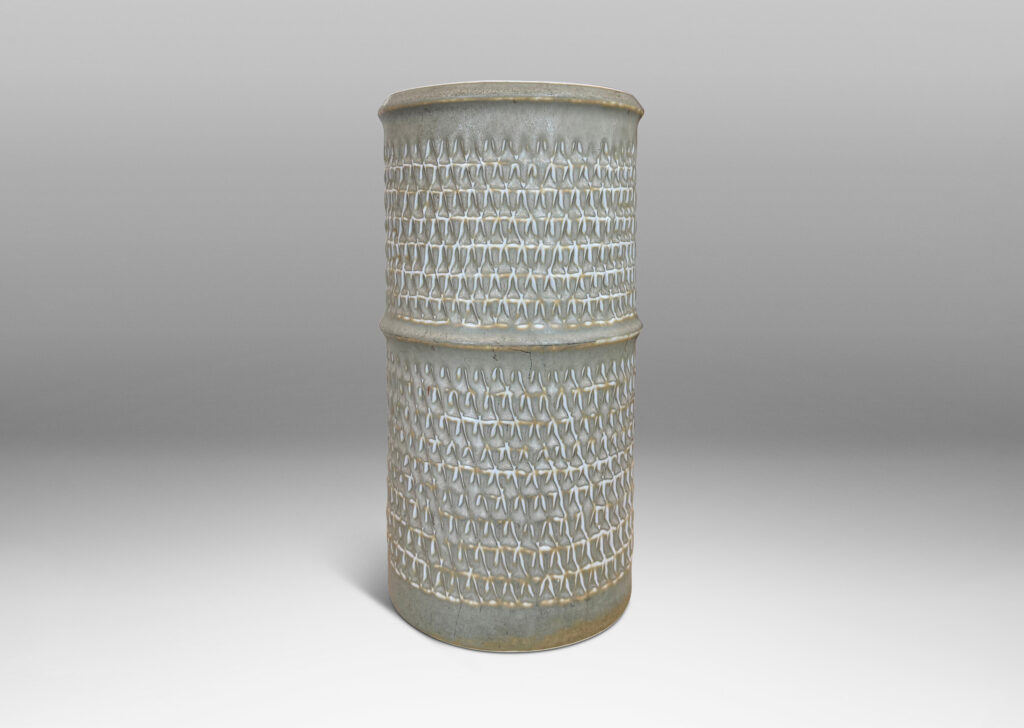 Gallery BAC cylindrical forms with notched bands and lips, and relief rows of triangle motifs, glazed in light warm gray