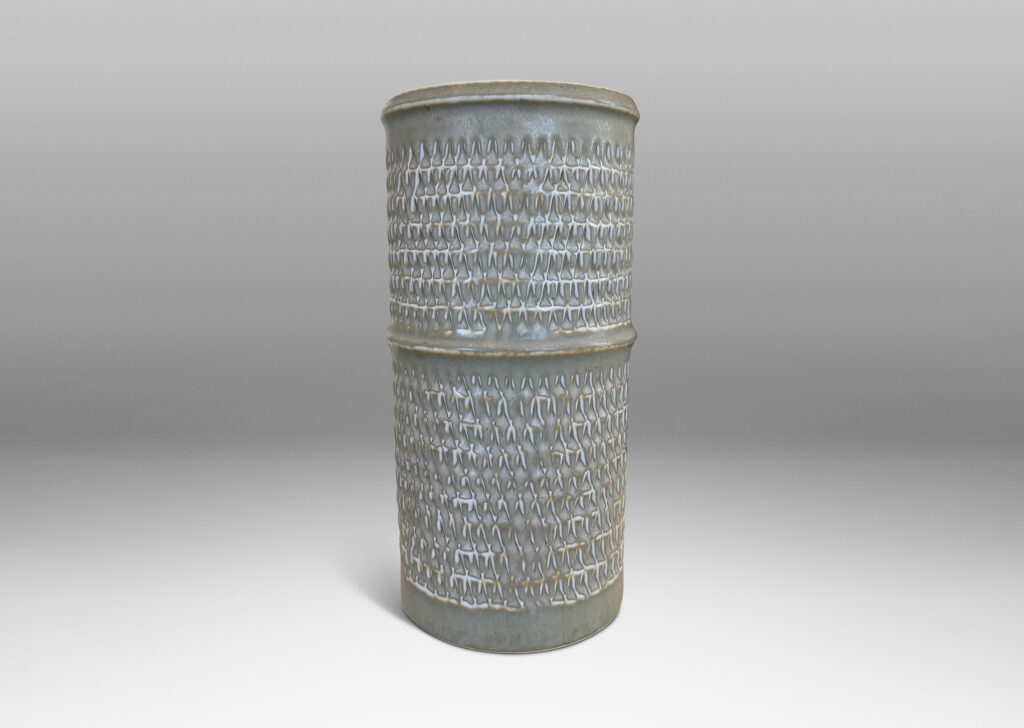 Gallery BAC cylindrical forms with notched bands and lips, and relief rows of triangle motifs, glazed in light warm gray