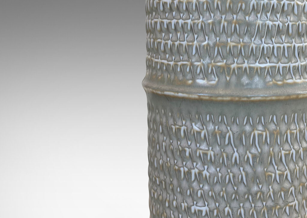 Gallery BAC cylindrical forms with notched bands and lips, and relief rows of triangle motifs, glazed in light warm gray