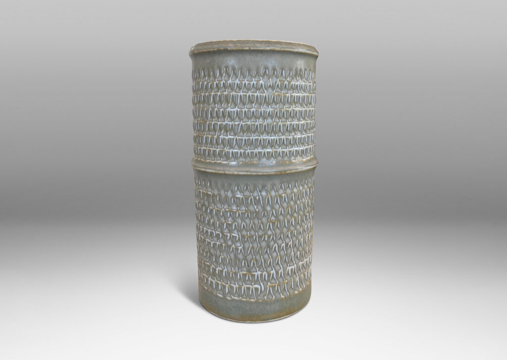 Gallery BAC cylindrical forms with notched bands and lips, and relief rows of triangle motifs, glazed in light warm gray