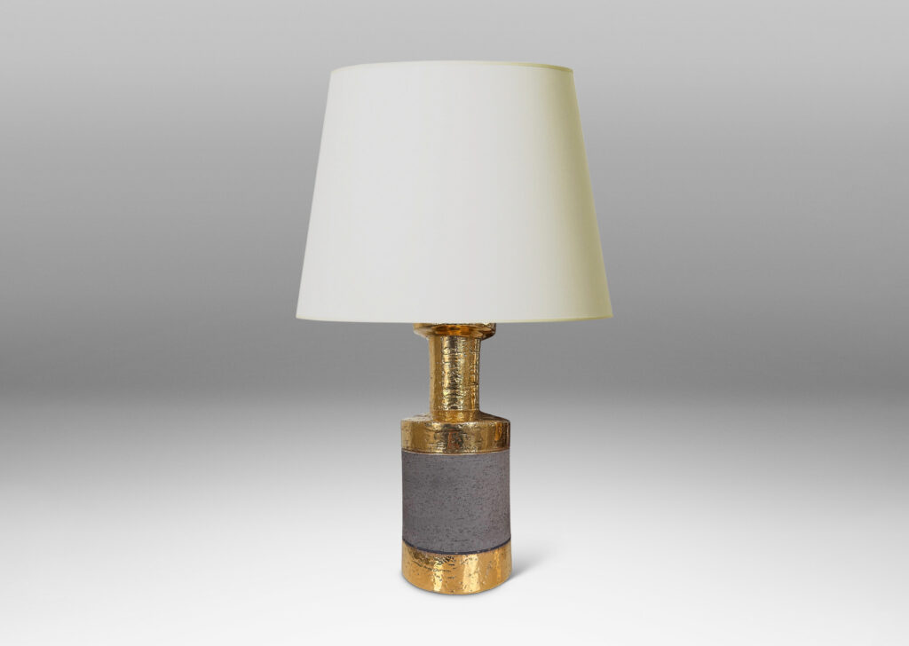 Gallery BAC canister forms with recessed necks and flange tops with a grog texture, glazed in gold luster and matte brown
