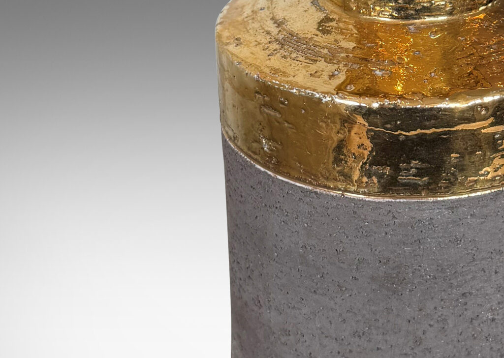 Gallery BAC canister forms with recessed necks and flange tops with a grog texture, glazed in gold luster and matte brown
