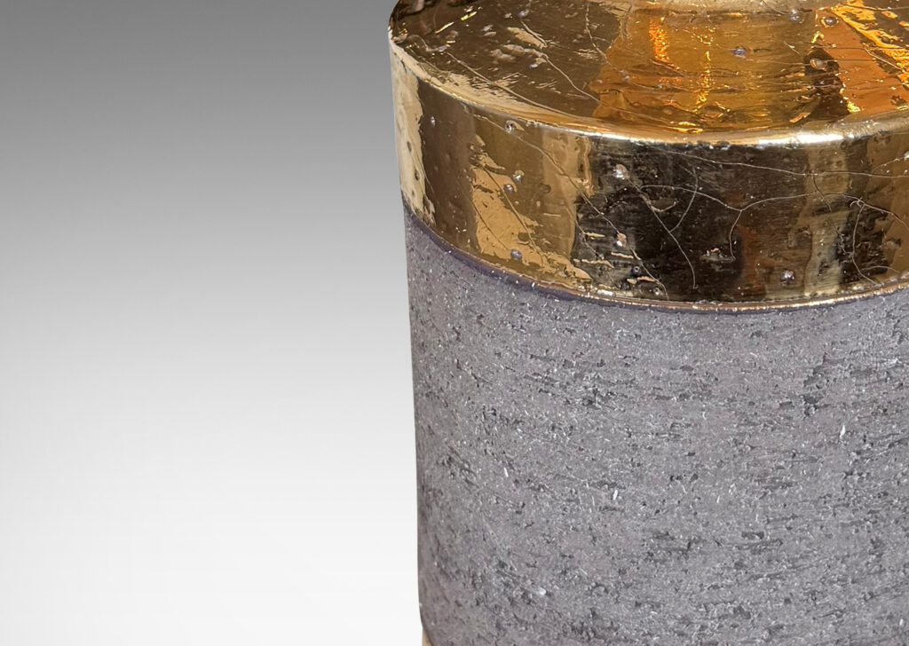 Gallery BAC canister forms with recessed necks and flange tops with a grog texture, glazed in gold luster and matte brown