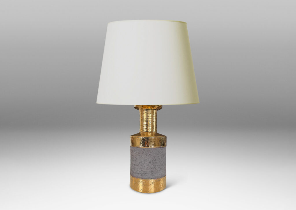 Gallery BAC canister forms with recessed necks and flange tops with a grog texture, glazed in gold luster and matte brown