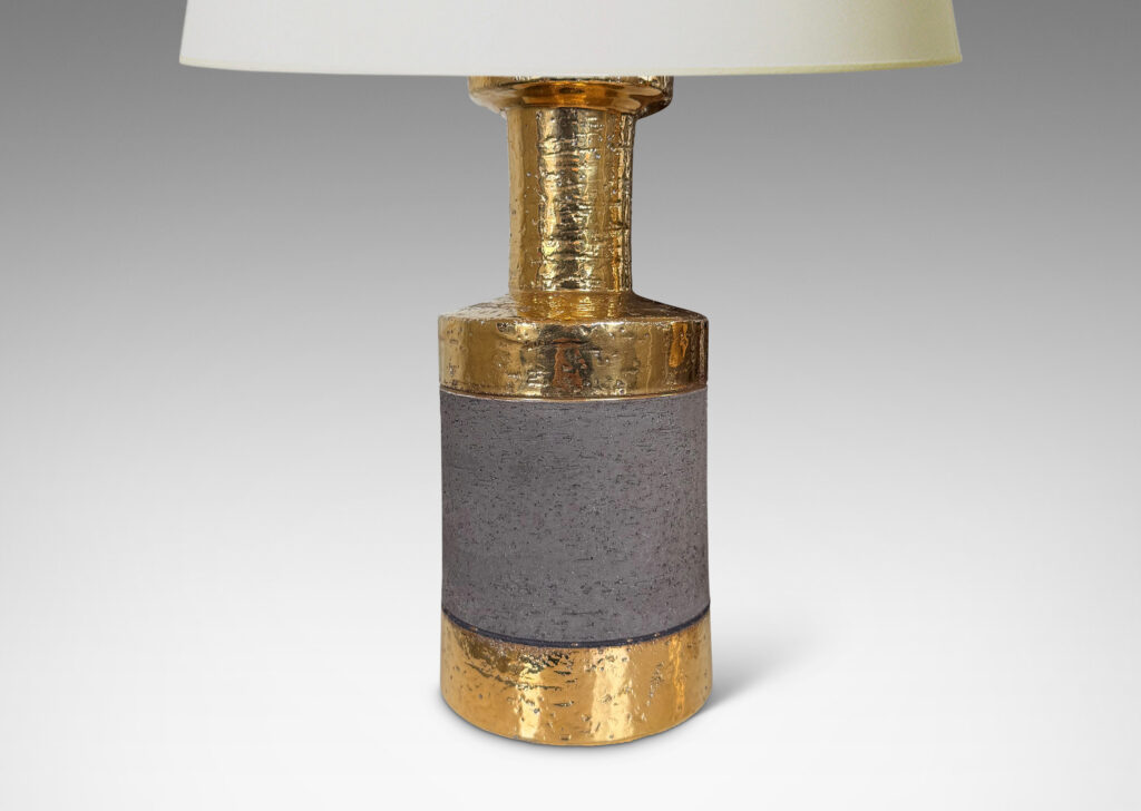 Gallery BAC canister forms with recessed necks and flange tops with a grog texture, glazed in gold luster and matte brown