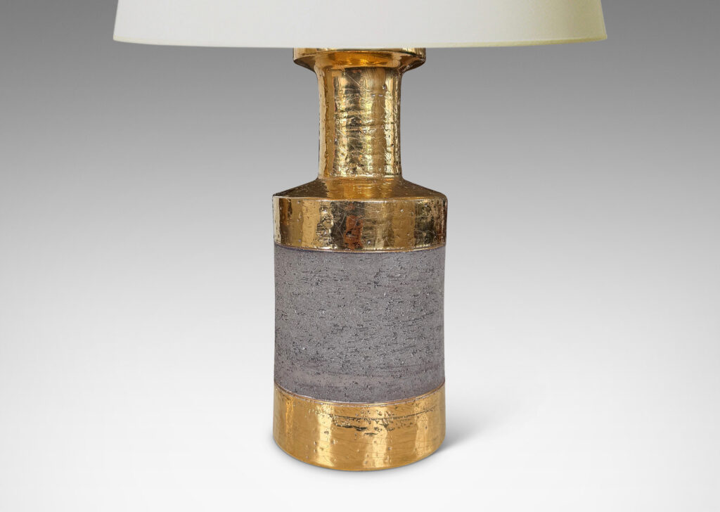 Gallery BAC canister forms with recessed necks and flange tops with a grog texture, glazed in gold luster and matte brown