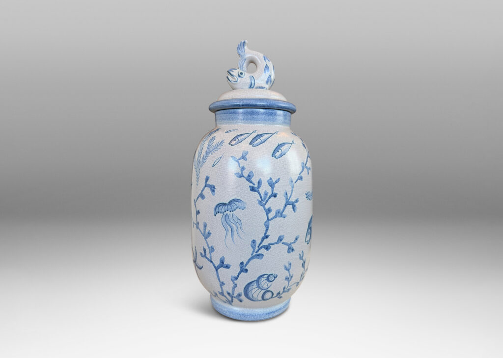 Gallery BAC tall ovoid form with fish form finial, glazed in a craquel very pale gray, surrounded with charming hand-painted pictures of marine flora and fauna in blue