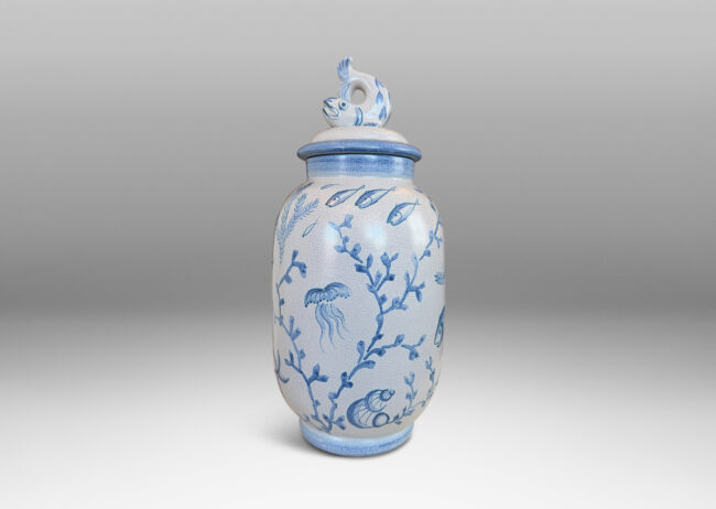Gallery BAC tall ovoid form with fish form finial, glazed in a craquel very pale gray, surrounded with charming hand-painted pictures of marine flora and fauna in blue
