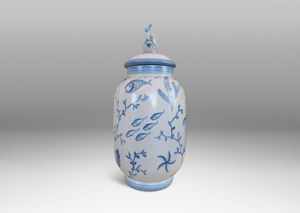 Gallery BAC tall ovoid form with fish form finial, glazed in a craquel very pale gray, surrounded with charming hand-painted pictures of marine flora and fauna in blue