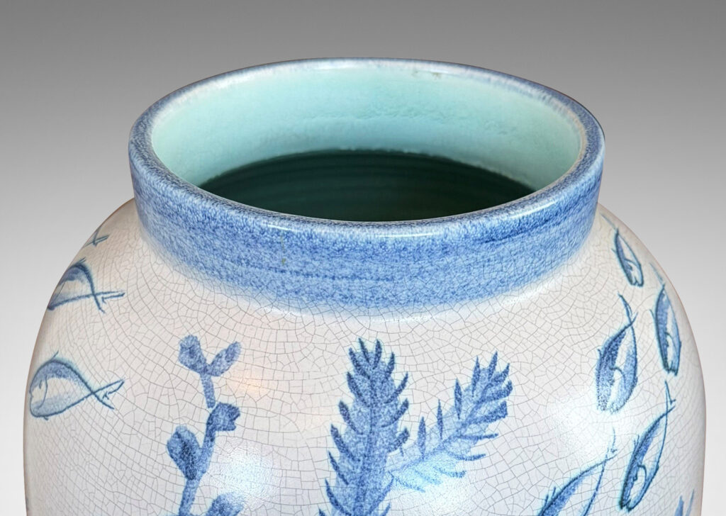 Gallery BAC tall ovoid form with fish form finial, glazed in a craquel very pale gray, surrounded with charming hand-painted pictures of marine flora and fauna in blue
