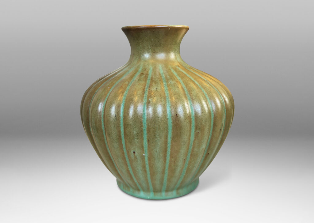 Gallery BAC tapered ribbed form with outstretched neck, glazed in celadon green-brown