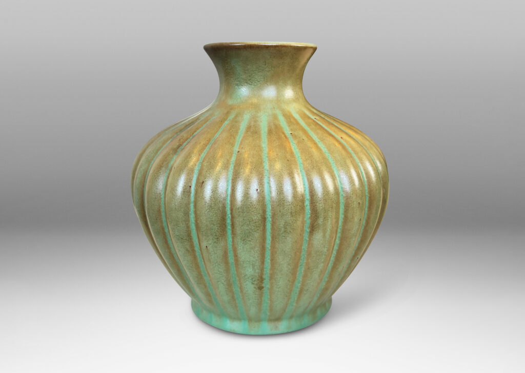 Gallery BAC tapered ribbed form with outstretched neck, glazed in celadon green-brown