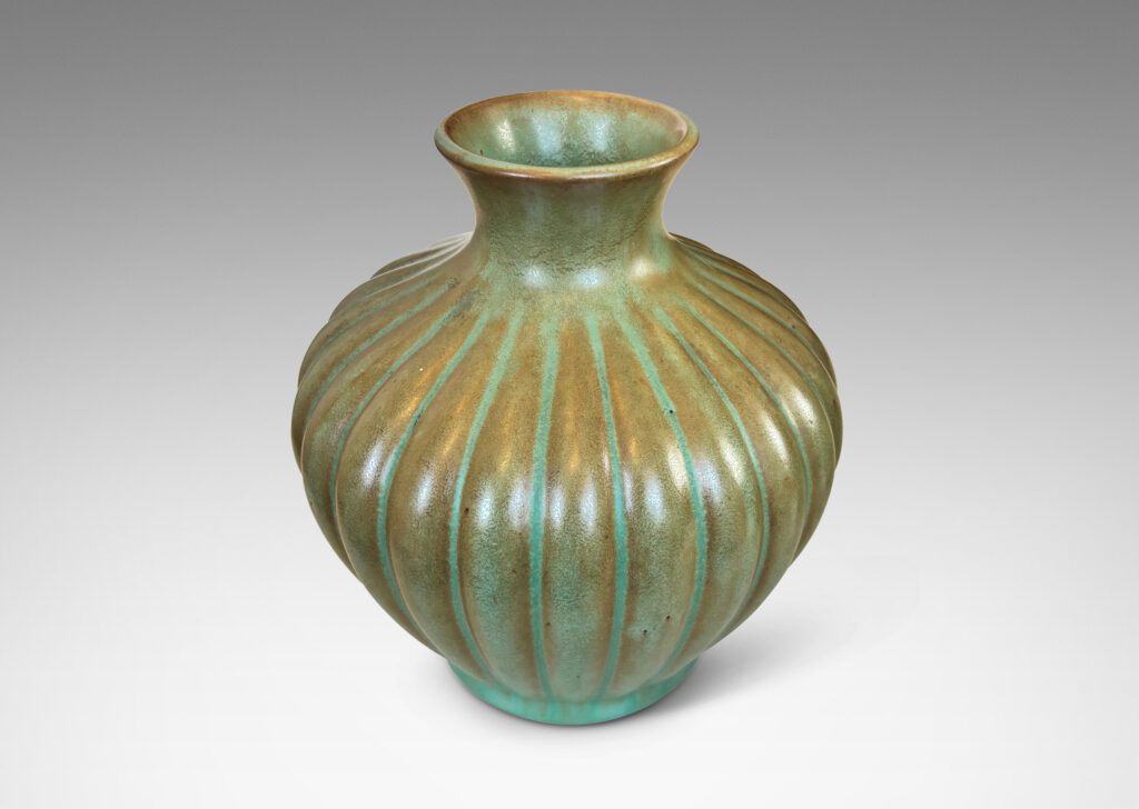 Gallery BAC tapered ribbed form with outstretched neck, glazed in celadon green-brown