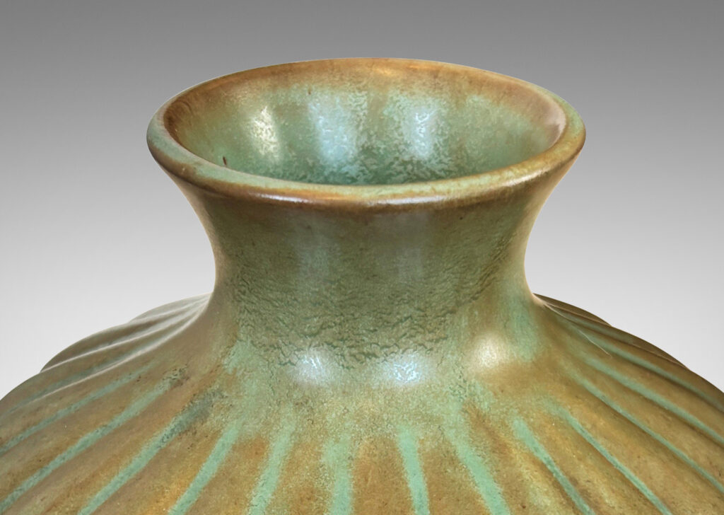 Gallery BAC tapered ribbed form with outstretched neck, glazed in celadon green-brown