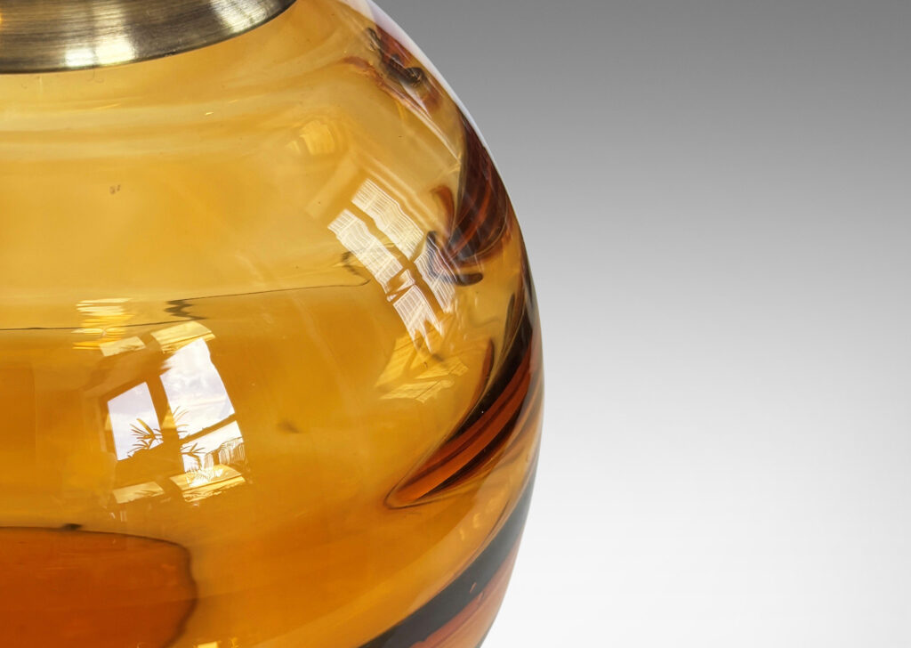 Gallery BAC globe form with internal horizontal banding, hand-blown in orange tint glass, brass mount