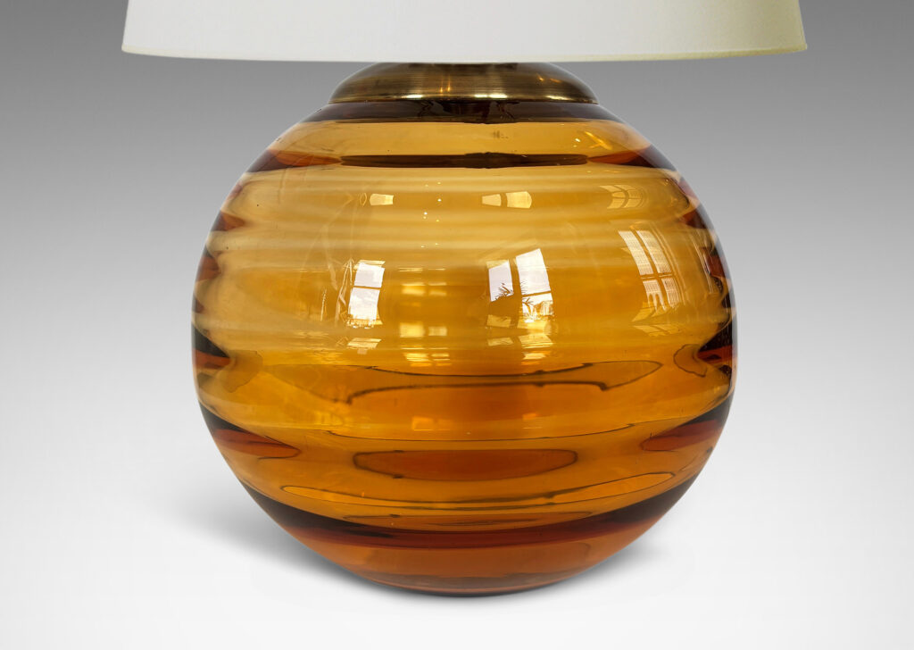 Gallery BAC globe form with internal horizontal banding, hand-blown in orange tint glass, brass mount