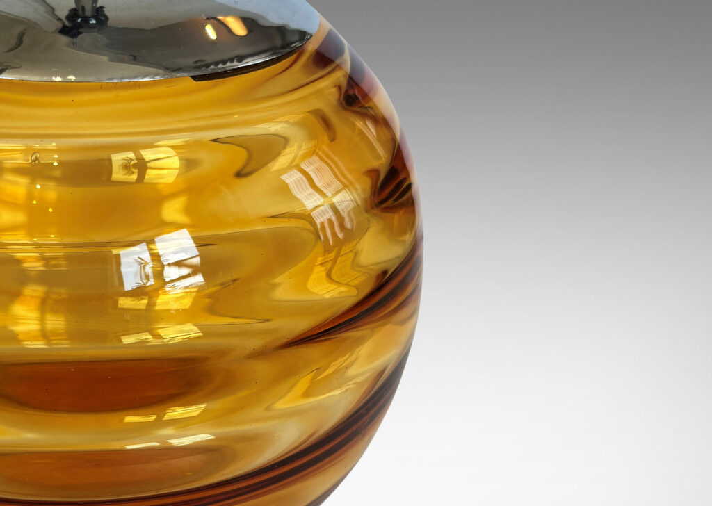 Gallery BAC globe form with internal horizontal banding, hand-blown in orange tint glass, steel mount