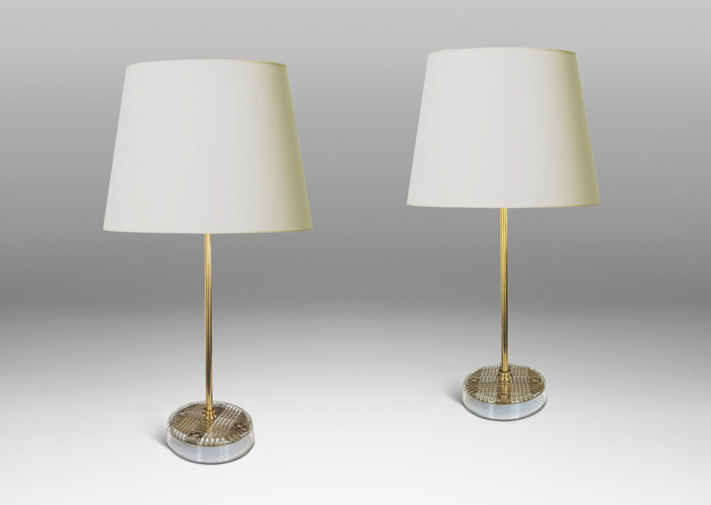 Gallery BAC disk bases in glass with reverse-cut crosshatch pattern, backed by a brass for a shimmering gold effect, with slender brass stands