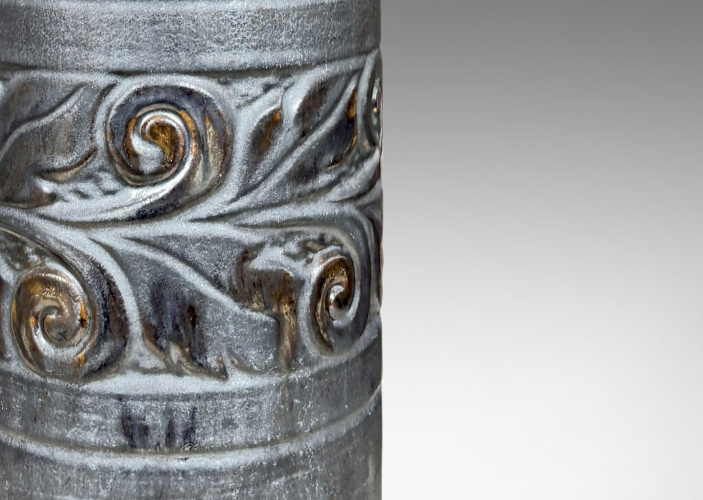 Gallery BAC columnar forms with relief bands of folk foliage, glazed in luster brown