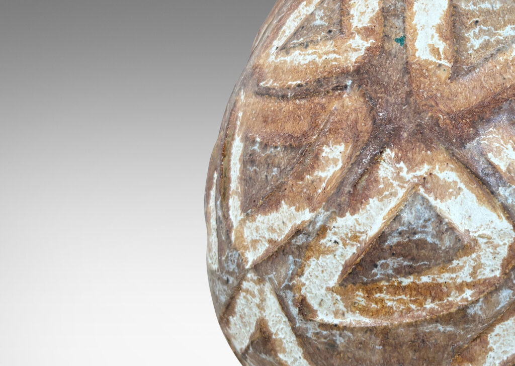 Gallery BAC ovoid form encircled in carved triangle motifs, glazed in warm and cool brown tone