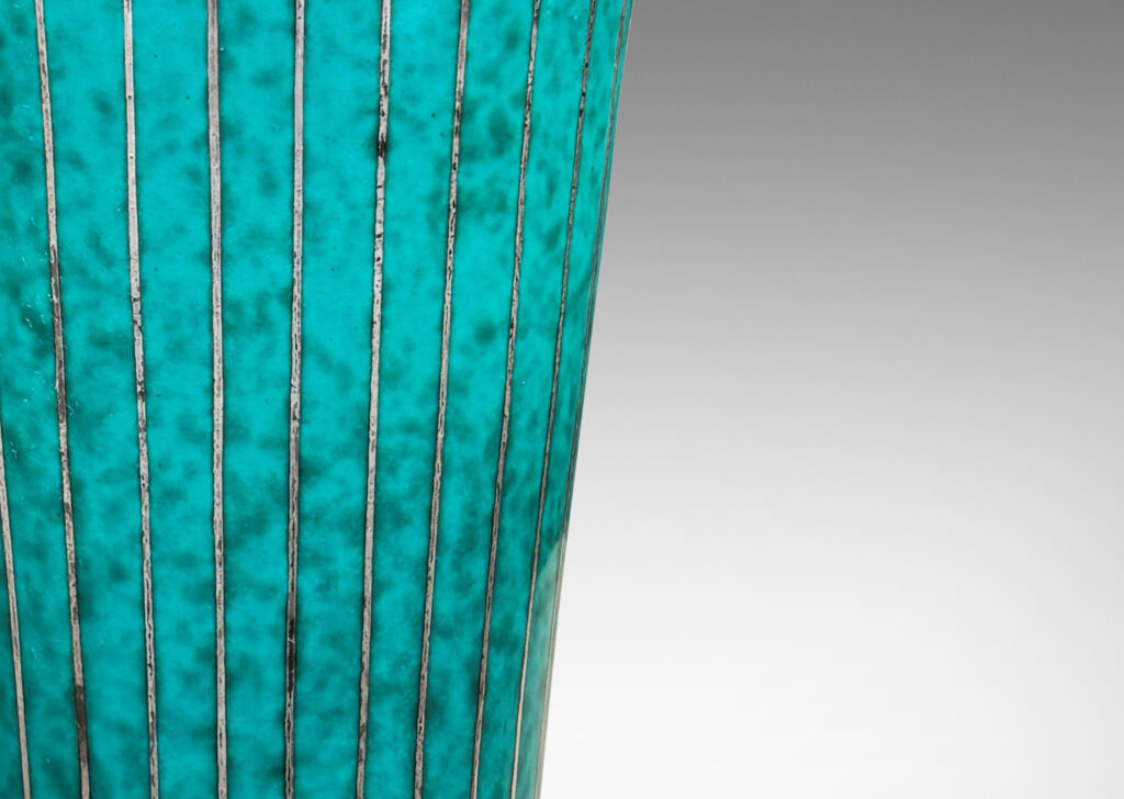 Gallery BAC tapered cylindrical form with a flanged and notched lip, glazed in a mottled blue-green