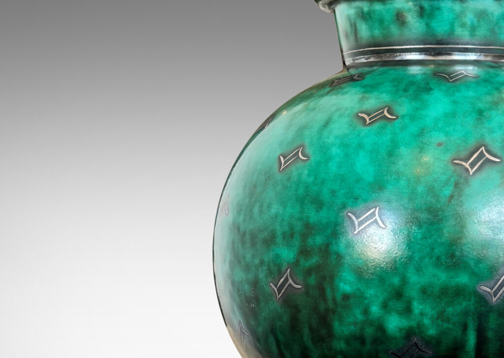 Gallery BAC globe form with flanged neck and base, glazed in a vivid mottled blue-green, with inlaid bands and floating motifs