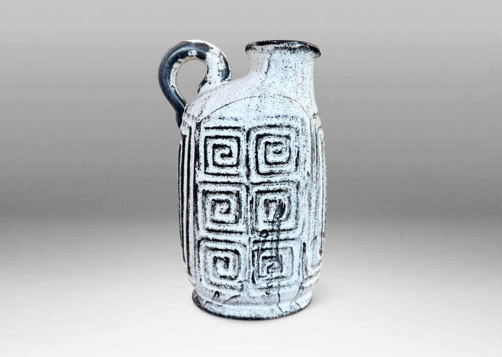 Gallery BAC compressed ovoid form, with spout mouth, loop handle, and Greek key relief design, glazed in white-black
