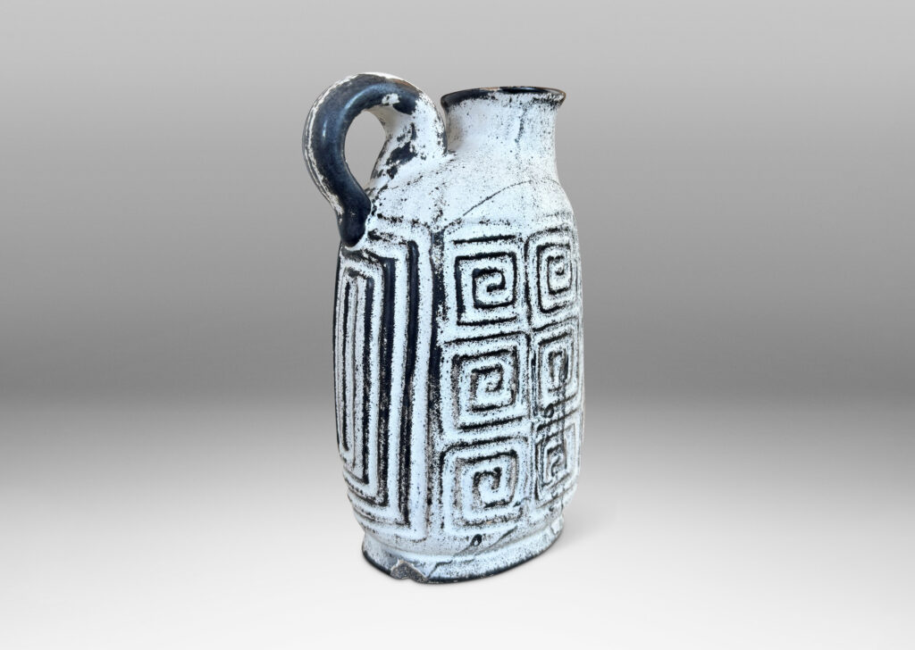 Gallery BAC compressed ovoid form, with spout mouth, loop handle, and Greek key relief design, glazed in white-black