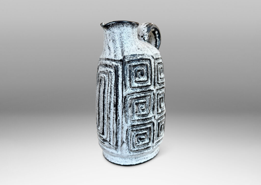 Gallery BAC compressed ovoid form, with spout mouth, loop handle, and Greek key relief design, glazed in white-black