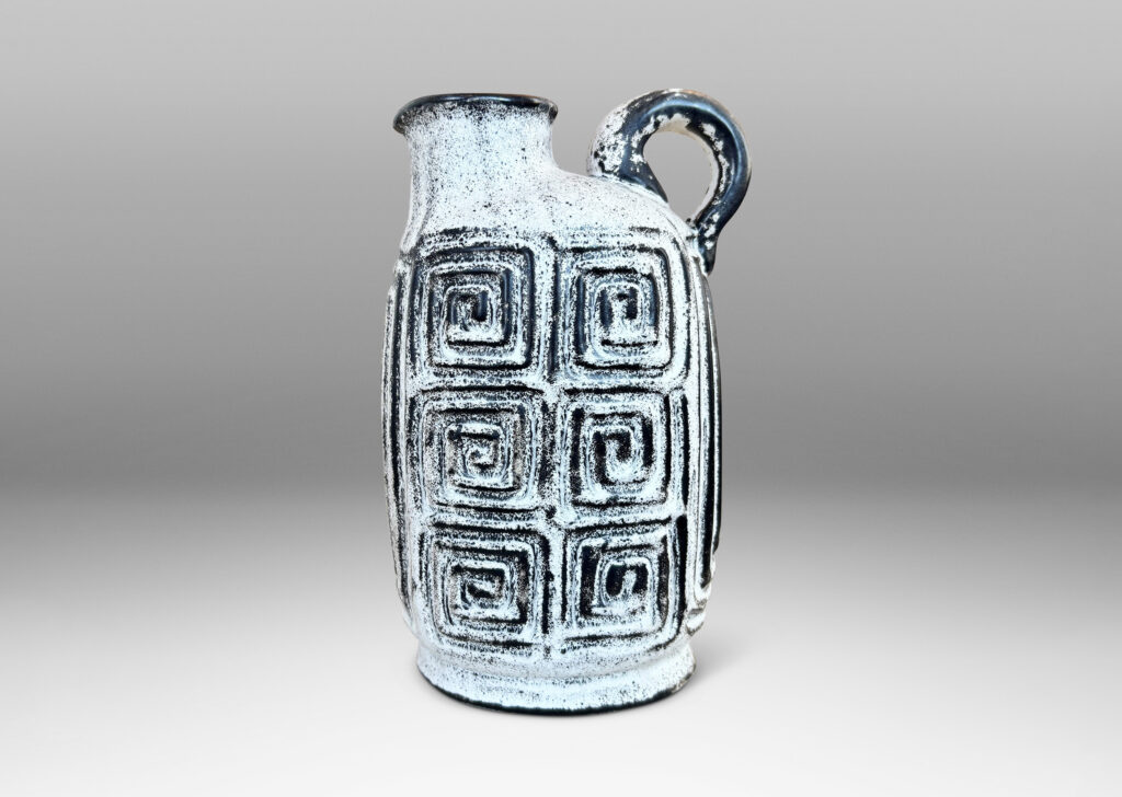 Gallery BAC compressed ovoid form, with spout mouth, loop handle, and Greek key relief design, glazed in white-black