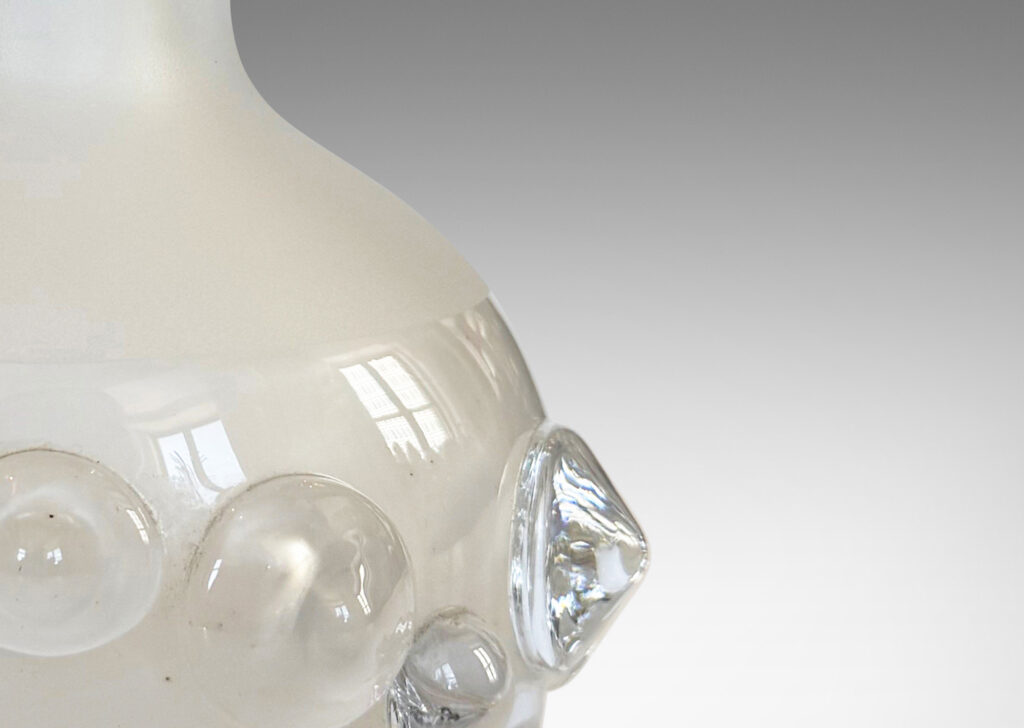 Gallery BAC decanter forms with attenuated necks and applied relief of demi-spheres in clear glass