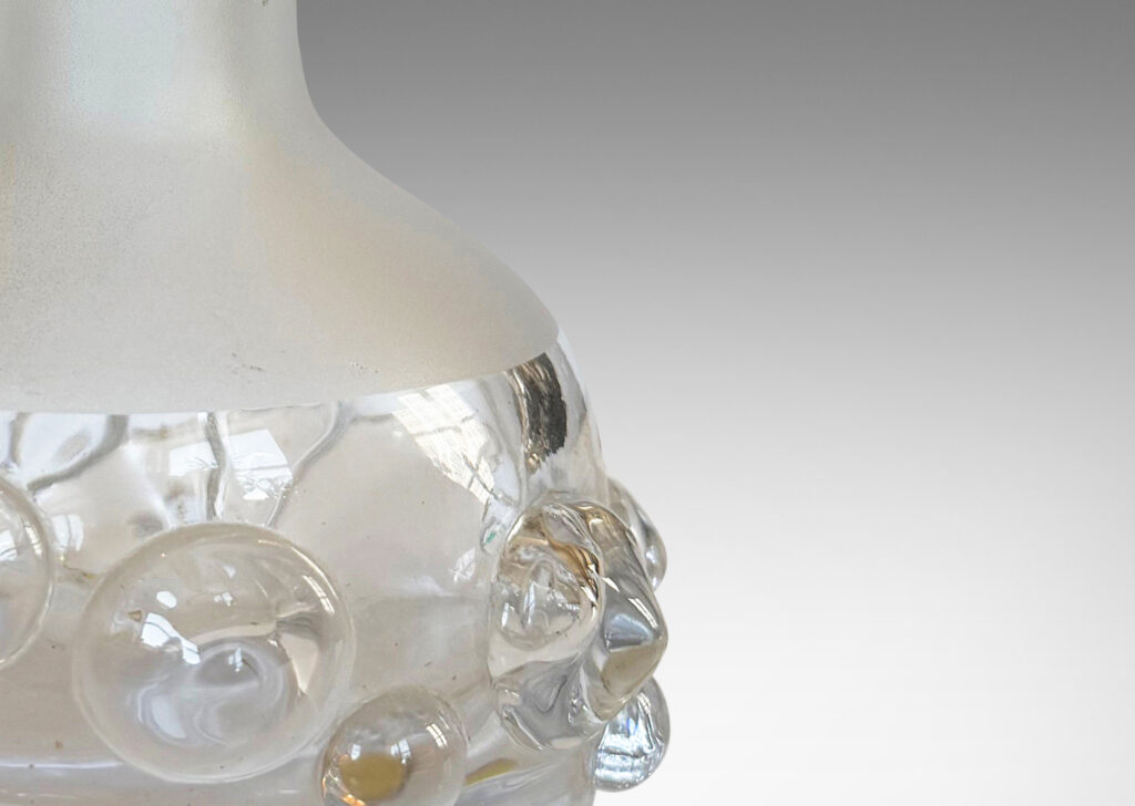 Gallery BAC decanter forms with attenuated necks and applied relief of demi-spheres in clear glass