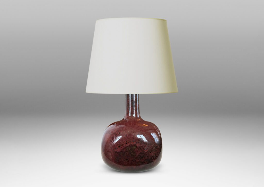 Gallery BAC gourd form, with squared globe body and tall neck, glazed in a deep oxblood burgundy with black accents