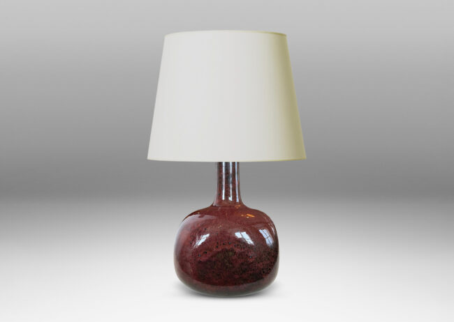Gallery BAC gourd form, with squared globe body and tall neck, glazed in a deep oxblood burgundy with black accents