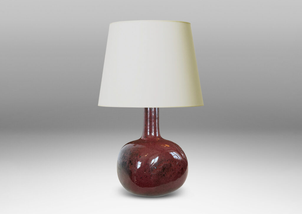 Gallery BAC gourd form, with squared globe body and tall neck, glazed in a deep oxblood burgundy with black accents