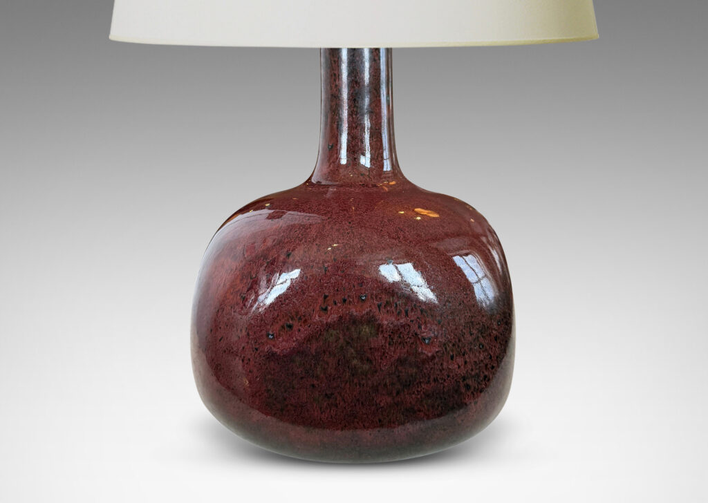 Gallery BAC gourd form, with squared globe body and tall neck, glazed in a deep oxblood burgundy with black accents