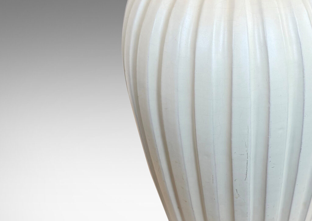 Gallery BAC vertically fluted tapering form in an eggshell finish pale ivory glaze