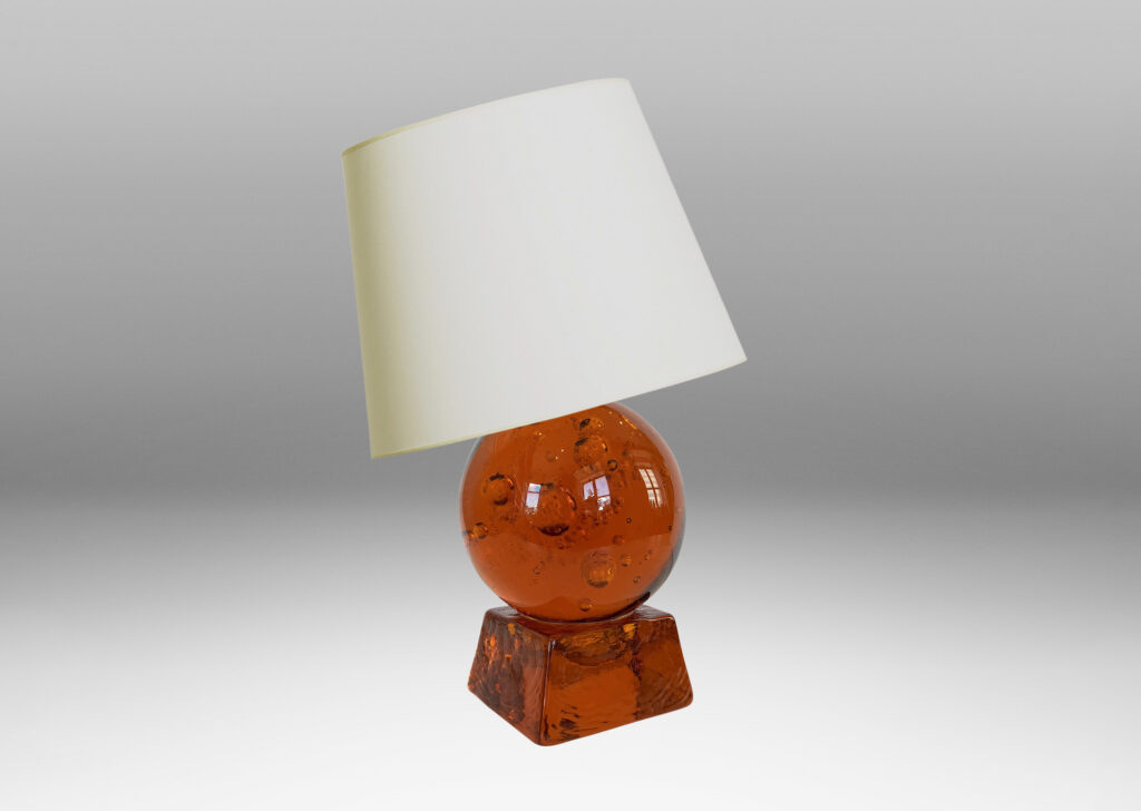 Gallery BAC amber tinted adjustable small globe with encased bubbles resting on a raked square base