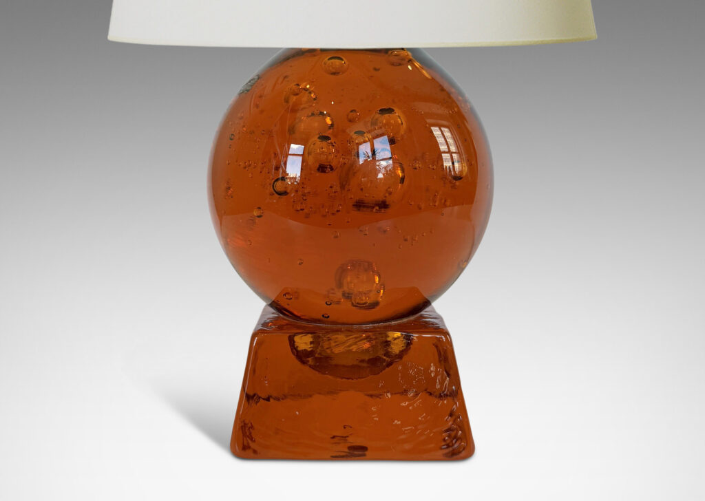 Gallery BAC amber tinted adjustable small globe with encased bubbles resting on a raked square base