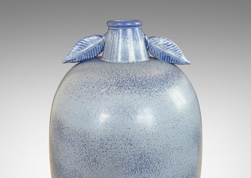Gallery BAC ovoid form with stem-like neck and leaves in high relief, glazed in light to deep tonal French blue