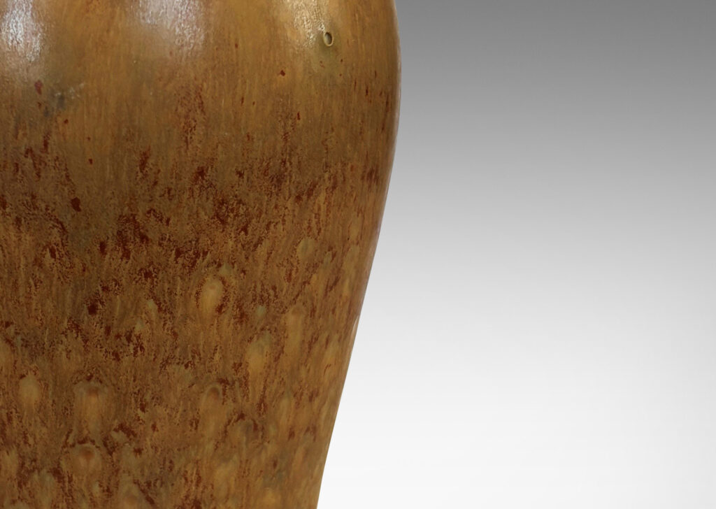 Gallery BAC sinuous form with swelling shoulders and a small conical neck, glazed in eggshell finish ochre-tan with red-brown
