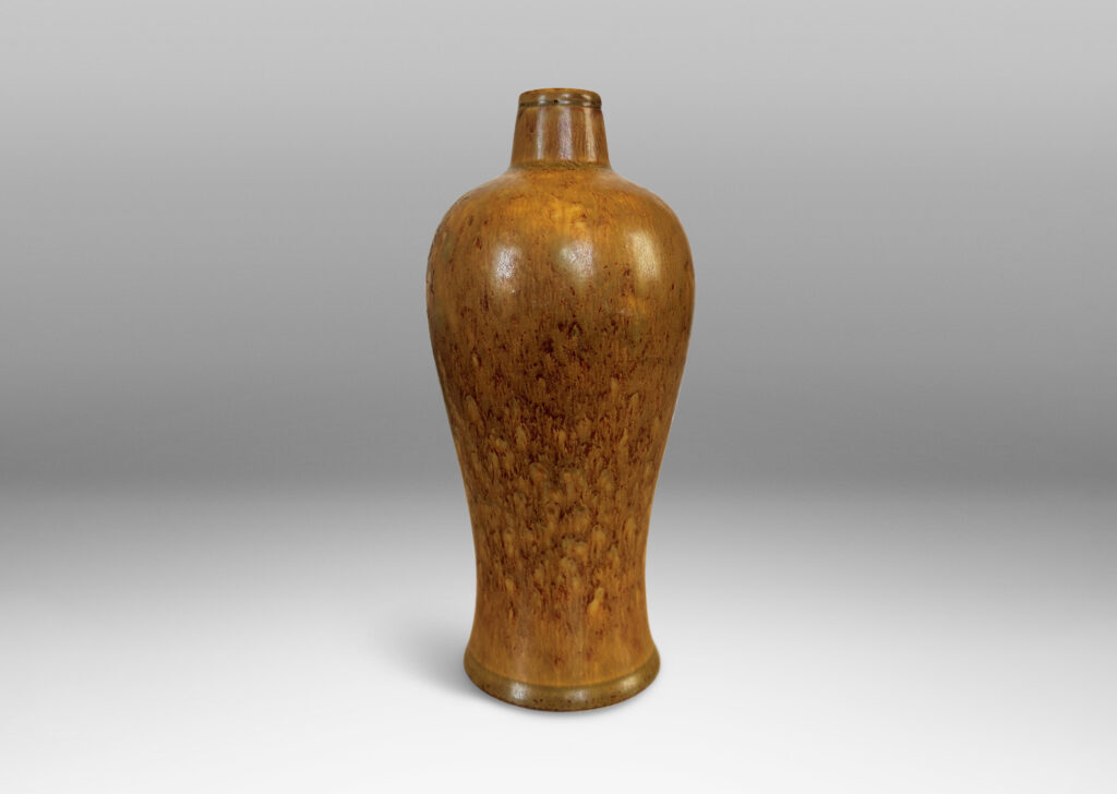 Gallery BAC sinuous form with swelling shoulders and a small conical neck, glazed in eggshell finish ochre-tan with red-brown