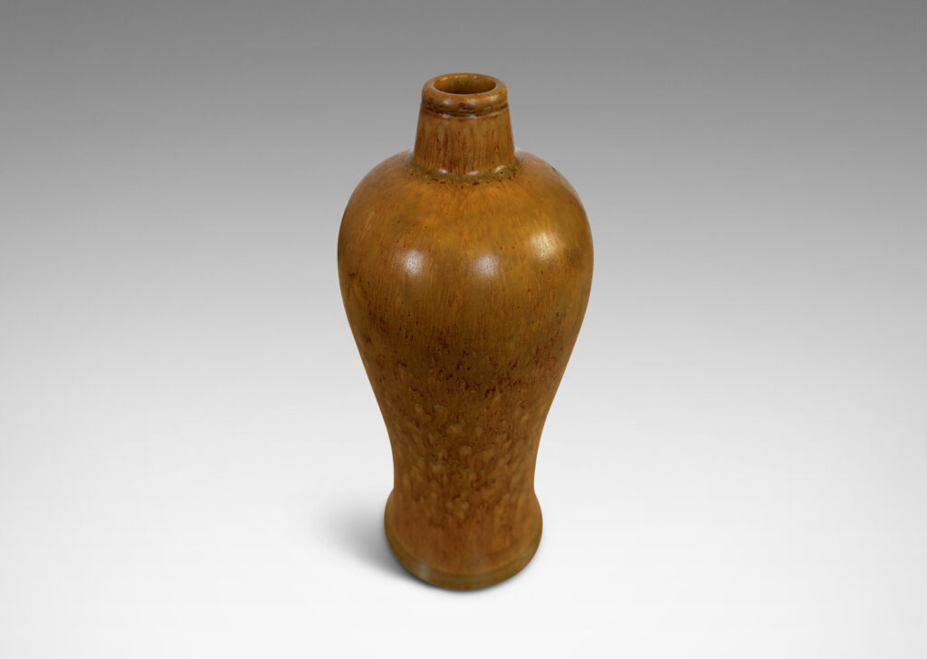 Gallery BAC sinuous form with swelling shoulders and a small conical neck, glazed in eggshell finish ochre-tan with red-brown